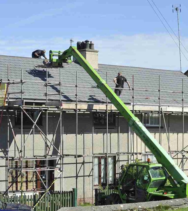 Commercial roofing team working on a large building in Austin, TX