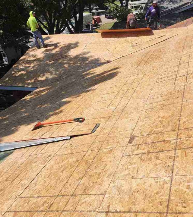 Roofer performing roof repairs on a home in Austin, TX