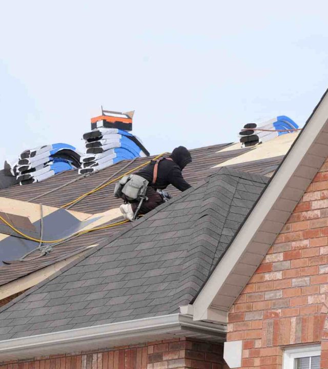 Roofer installing a new roof on a home in Austin, TX