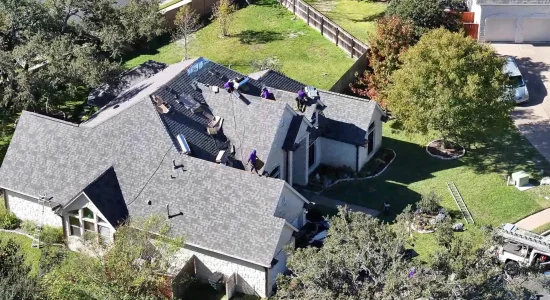 Trusted residential roofing team working on a home in Austin, TX