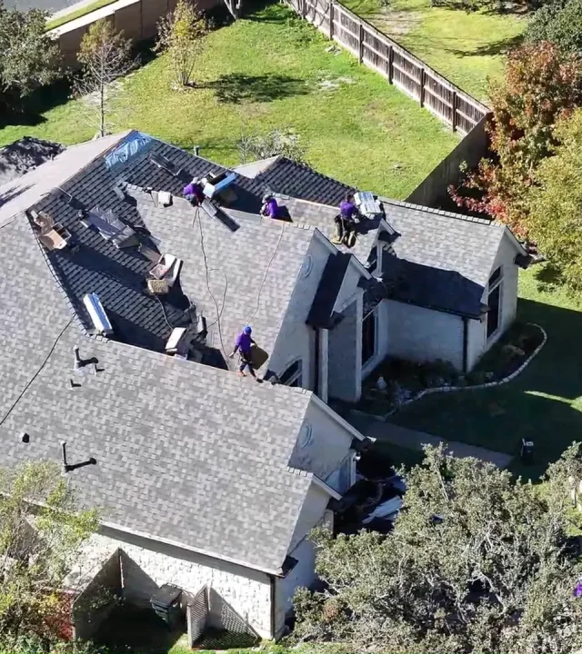 Trusted residential roofing team working on a home in Austin, TX